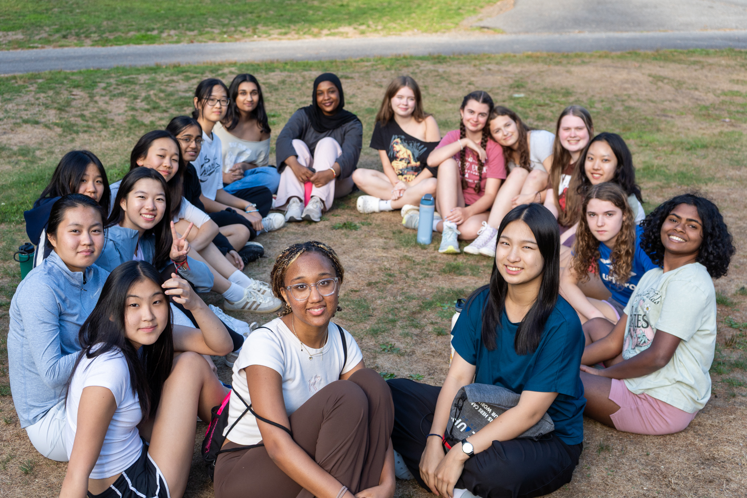 A group of female high school students sitting in a circle together