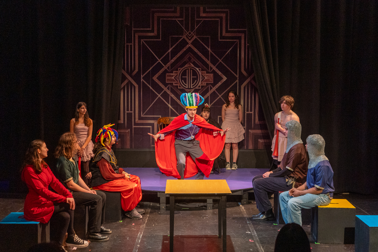 A group of students in a play dressed in medieval costumes